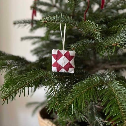 A patchwork Christmas decoration made with red and white fabric