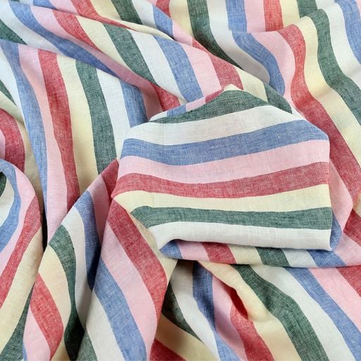 A close-up of fabric with diagonal stripes in pastel pink, blue, green, yellow, and red. Soft folds create gentle creases and shadows—perfect for practising sewing tricks to help you sew faster.